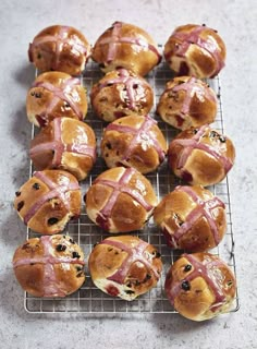 freshly baked hot cross buns on a cooling rack ready to be eaten for lunch