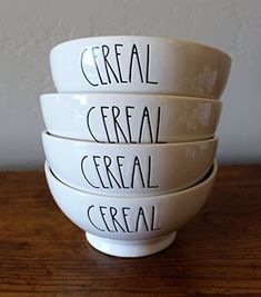 four white bowls with words written on them