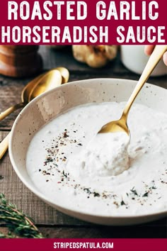 a spoon in a bowl filled with yogurt and sprinkled with herbs