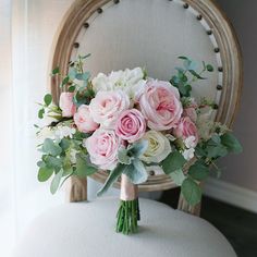 a bouquet of flowers sitting on top of a chair