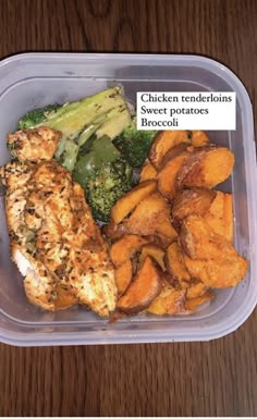 a plastic container filled with chicken, sweet potatoes and broccoli