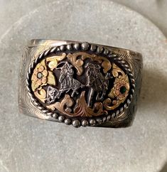 Bold Beautiful Hand Crafted Mexican Cowboy riding horses Sterling Silver Rose Gold Emerald Cuff Bracelet Solid in weight, slightly adjustable Measures 1 1/2 inch wide Adjustable Engraved Wide Band Cuff Bracelet, Adjustable Wide Band Engraved Cuff Bracelet, Hand Tooled Luxury Formal Jewelry, Luxury Hand Tooled Jewelry For Formal Occasions, Western Style Cuff Jewelry For Gift, Western Style Cuff Bangle Bracelet Gift, Adjustable Engraved Jewelry With Thick Band, Adjustable Engraved Thick Band Jewelry, Western Style Stamped Cuff Bracelet