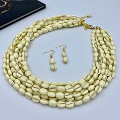 Elevate your style with our Elegant Ivory White Multi Strand Necklace. This chunky beaded statement piece is handcrafted with multiple layers of smooth ivory beads, offering a sophisticated touch to any outfit. Perfect as a thoughtful gift for her, this necklace is designed to impress, making it an exquisite addition to any woman's jewelry collection. This is a handcrafted necklace, uniquely designed with attention to every detail. - Necklace length is 17.5" long, 7 STRANDS plus additional 4 inc Luxury White Artisan Necklace, Luxury Handmade Long Necklace For Gift, Luxury White Beaded Statement Necklaces, Luxury White Multi-strand Necklace, Luxury White Multi-strand Beaded Necklaces, Luxury Multi-strand Jewelry Statement Piece, Luxury White Artisan Beaded Necklaces, Luxury Long White Beaded Necklaces, Luxury Statement Multi-strand Beaded Necklace