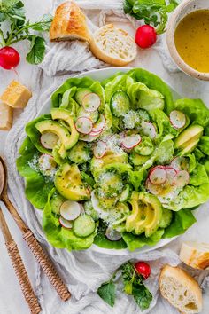 a bowl filled with lettuce, radishes and cheese