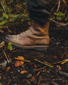 a person standing on the ground wearing brown boots