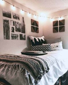 a bedroom with pictures on the wall and lights strung from the ceiling over the bed