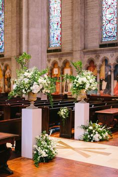 flowers are placed in vases at the alter