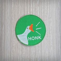 an embroidered patch with the words honk on it