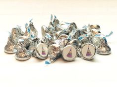 a pile of silver foil wrapped candies sitting on top of each other