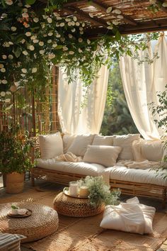 a living room filled with lots of white furniture and flowers on the wall above it