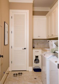 a white washer and dryer sitting inside of a room next to a doorway