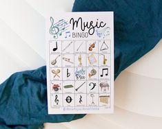 a poster with musical symbols on it sitting on a blue sheet next to a pillow