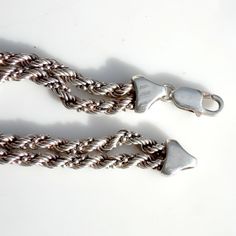 Wonderful double-stranded sterling silver bracelet - the links are twisted into a spiral. Stamped Milor, 925 and Italy. Measures 7 1/2 inches long. Width (both strands together) is 3/8 of an inch. Circa 1980. Sturdy construction with a large lobster claw clasp that closes securely. Weight is 16.4 grams or .58 oz. Excellent vintage condition with minor surface wear and some patina. Sterling Silver Bracelet With A Modern Twist, Elegant Twisted Silver Bracelets, Elegant Silver Twisted Bracelet, Adjustable Twisted Silver Bracelets, Classic Twisted Silver Jewelry, Classic Silver Twisted Jewelry, Silver Adjustable Twisted Bracelets, Silver Rope Chain Bracelet As Gift, Silver Multi-strand Sterling Silver Bracelet