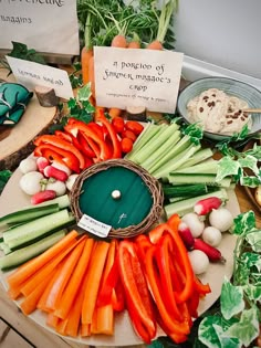 carrots, celery, and other vegetables are arranged on a platter