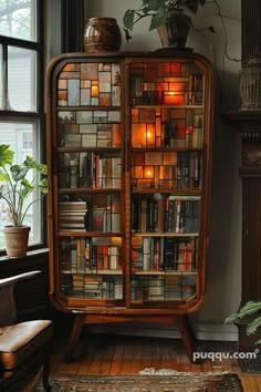 an old bookcase with many books on it in front of a window filled with potted plants