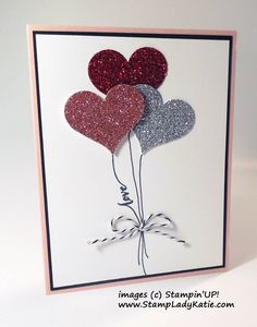 a card with three heart balloons attached to it