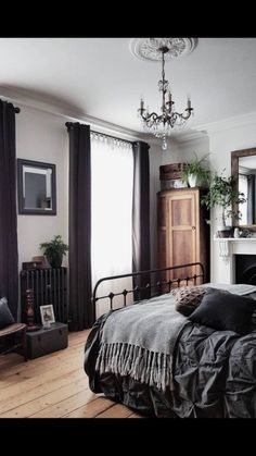 a bedroom with a bed, mirror and fireplace in it's centerpieces