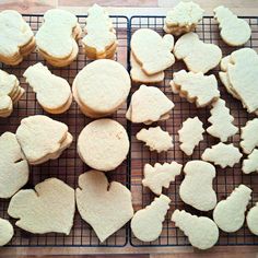 several heart shaped cookies on a cooling rack with one cut in half and the other uncooked