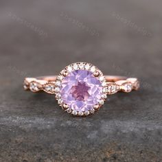 Handmade with natural lavender amethyst - a unique pale purple gemstone, and adorned with sparkly simulated diamonds, this gorgeous ring is meticulously crafted. This is a Vintage Engagement ring with Lavender Amethyst and Cubic Zircon. This ring is marked S925/G10K/G14K Main stone is 7mm Round Cut Natural Lavender Amethyst, halo stones are cubic zirconia. Best Gift for Engagement,wedding,birthday gift. I accept custom making order.Please contact me if you need this service. All the jewelry in m Pink Amethyst Ring With Halo Setting, Elegant Lavender Birthstone Ring For Weddings, Pink Amethyst Gemstone Ring, Purple Amethyst Ring For Wedding, Kunzite Wedding Jewelry With Center Stone, Pink Amethyst Anniversary Ring, Purple Birthstone Ring With Round Stone For Wedding, Wedding Jewelry With Kunzite Center Stone, Purple Birthstone Ring For Wedding With Round Stone