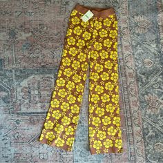 Brand New With Tags. Tan With Yellow Floral Pattern. Size: Small (Australia 6-10) The Knit Pant Is A Fitted Pant With An Elastic Waist. Fitted Yellow Floral Print Pants, Yellow Floral Print Long Pants, Vintage Wide Leg Yellow Pants, Vintage Wide Leg Yellow Bottoms, Vintage Yellow Wide-leg Bottoms, Yellow Retro Pants For Fall, Retro Yellow Pants For Fall, Yellow Fitted Retro Pants, Retro Fitted Yellow Pants