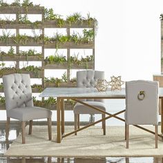 a dining room table and chairs with plants growing on the wall behind them in an indoor setting