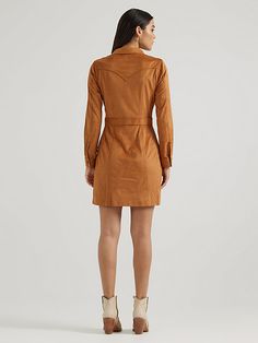 With a luxurious look and feel, the Women’s Wrangler Retro® Sueded Western Snap Shirt Dress will become your first pick for every special occasion. This vintage-inspired dress is crafted from a soft fabric blend with just a little stretch for extra comfort. It features all the Western-inspired details, including chest flap pockets with our signature ‘W’ stitching, pointed yokes from front to back, a banded waist for a flattering fit, and branded hardware for authenticity. Fitted Shirt Dress For Fall Dress Down, Fall Cotton Mini Dress For Date Night, Cotton Mini Dress For Fall Date Night, Fitted Cotton Shirt Dress For Fall, Cotton Dresses For Date Night In Fall, Boho Cowgirl Style, Western Dresses For Women, Western Vintage, Retro Western