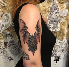 a woman with a bat tattoo on her arm