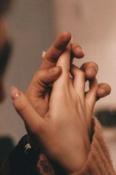 two hands touching each other with their fingers