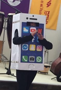 a person in a cardboard box costume holding an iphone