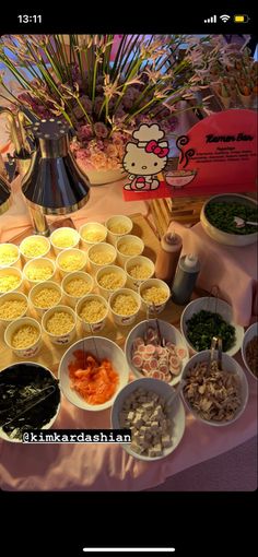 a table topped with lots of different types of food next to a vase filled with flowers