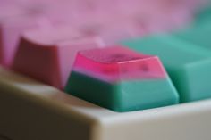 a close up view of a pink and blue keyboard