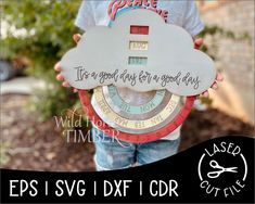 a little boy holding up a paper plate with words on it and a cloud in the middle