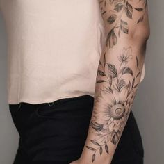 a woman with a flower tattoo on her arm