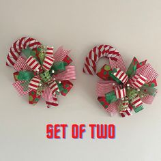 two red and green christmas bows with the words set of two on top of it