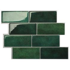 a green tile wall that has been painted in shades of dark green and light green