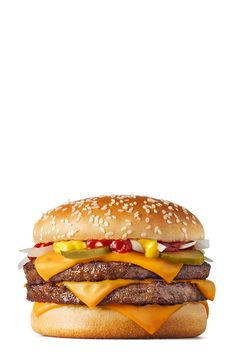 a hamburger with cheese, ketchup and pickles