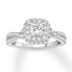 an engagement ring with a square diamond center surrounded by small round diamonds on the band