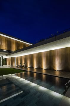 an empty pool in front of a building at night