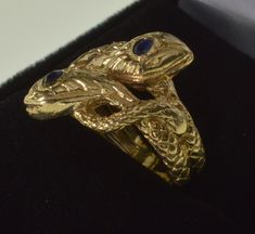 "Gorgeous Victorian 14K gold double snake love knot pinky ring size 4. This beautiful ring is a remarkable specimen of Victorian love token jewelry. The top of the ring designed as 2 intertwined snakes with elaborate heads and looping tails. They are dimensional with well pronounced scales. The heads are adorned with 2 faceted blue sapphire gems approx. 2.5 mm across. The ring top is 20 mm between the tips of the snakes snouts. The whole ring is 20 mm in its widest. There is a maker's stamp \"f\ Antique Hallmarked Snake Ring, Gold Snake-shaped Ring For Anniversary, Antique Snake Ring As Gift, Elegant Hallmarked Snake Ring, Vintage Snake-shape Jewelry For Formal Occasions, Unique Gold Snake Ring For Formal Events, Unique Gold Snake Ring For Formal Occasions, 14k Gold Snake Shape Ring For Anniversary, Unique Yellow Gold Snake Ring For Promise