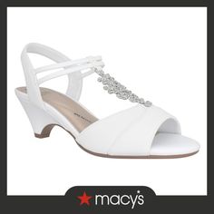 a woman's white high heel sandal with jewel embellishment