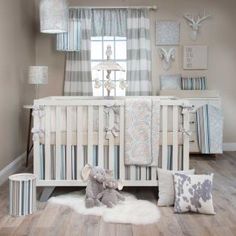 a baby's room is decorated in gray and white