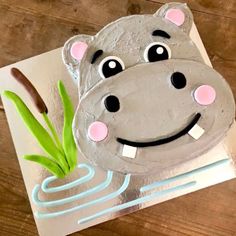 a cake shaped like a hippopotamus on top of a piece of paper