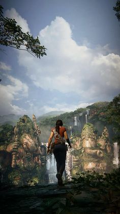 a man walking across a lush green forest filled with lots of tall rocks and trees