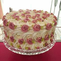 there is a cake that has pink flowers on the top and white frosting on the bottom