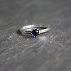 Do you need a gift for someone with a September birthday or to celebrate your 5th wedding anniversary? This sterling silver synthetic sapphire stacking ring is perfect if your birthstone is sapphire or you need a simple navy blue ring. Here are the details:This ring is made with either a rose cut (faceted) or smooth 5mm synthetic sapphire cabochon set in a sterling silver bezel and on a sturdy band handmade in your size. It can be worn with other stackable rings, or by itself.Please select your Navy Blue Ring, Plain Silver Rings, Sapphire Cabochon, 5th Wedding Anniversary, Sea Glass Ring, Silver Lab, September Birthday, Blue Ring, Glass Rings