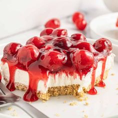 a piece of cheesecake with cherries on top