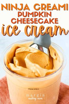 an ice cream in a glass container with a spoon sticking out of it and text overlay that reads, ninja cream pumpkin cheesecake ice cream