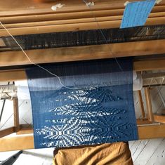 a weaving machine with blue and white designs on it's warpning cloths