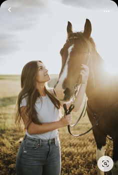 a beautiful young woman standing next to a horse