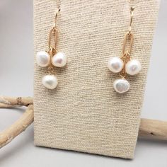 Three stones dangle from brass chain. Great for all ages, these simple earrings are easily dressed up or down. All pieces will be packaged together in a cotton filled jewelry box unless otherwise specified. Please let us know if your order is a gift and we will gladly include a handwritten note and complimentary gift wrap. Handmade White Pearl Earrings In 14k Gold Filled, Dainty Metal Drop Pearl Earrings, White Gold Plated Dangle Jewelry, Delicate Brass Jewelry For Gifts, Minimalist 14k Gold-filled Dangle Jewelry, Handmade White Gold-plated Earrings, Dainty Teardrop Pearl Drop Jewelry, Handmade Gold Pearl Earrings For Gift, Handmade Gold Pearl Earrings As A Gift